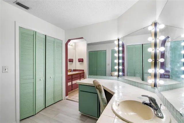 a en suite bathroom with a granite countertop sink a toilet and shower