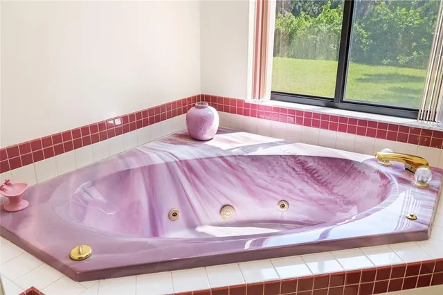 a bathroom with a bathtub and window