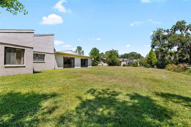 a house view with swimming pool in front of it