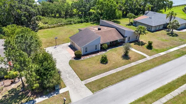 an aerial view of residential house with outdoor space and swimming pool