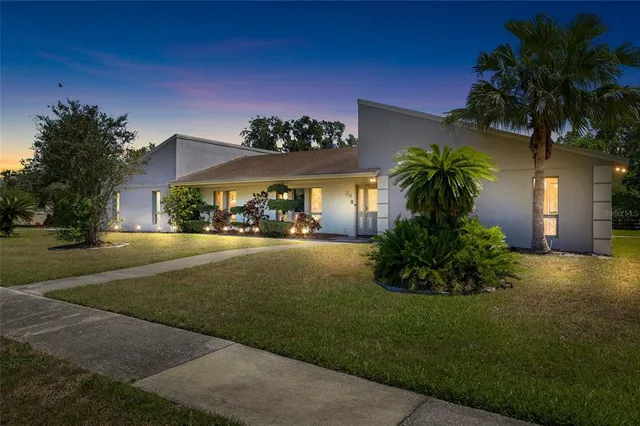 a view of house with outdoor space and garden