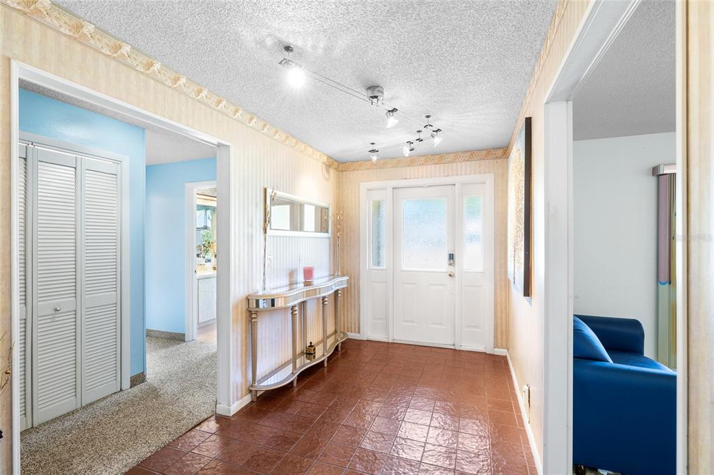 34 Misty Meadow Lane Mulberry, FL 33860 - Photo 7 of 49 a view of a hallway with bathroom and wooden floor