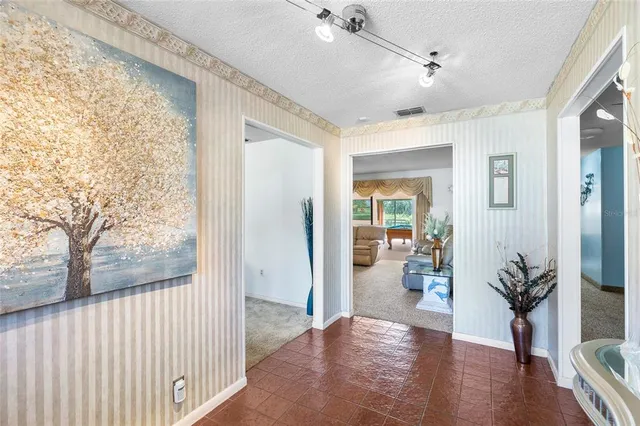a view of a hallway and dining room with wooden floor