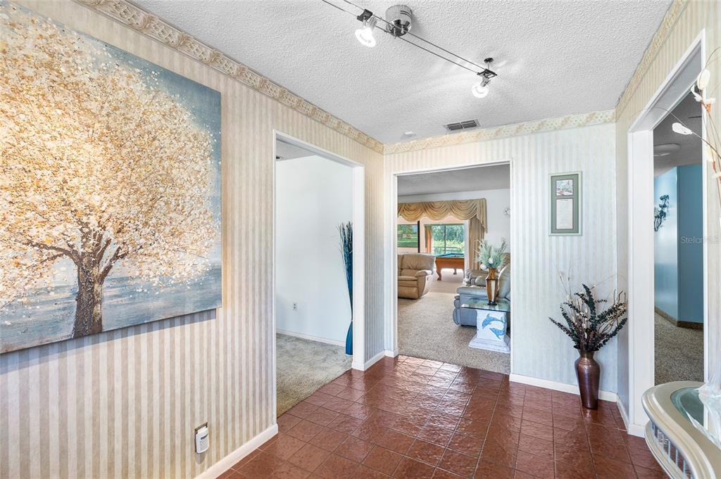 34 Misty Meadow Lane Mulberry, FL 33860 - Photo 8 of 49 a view of a hallway and dining room with wooden floor