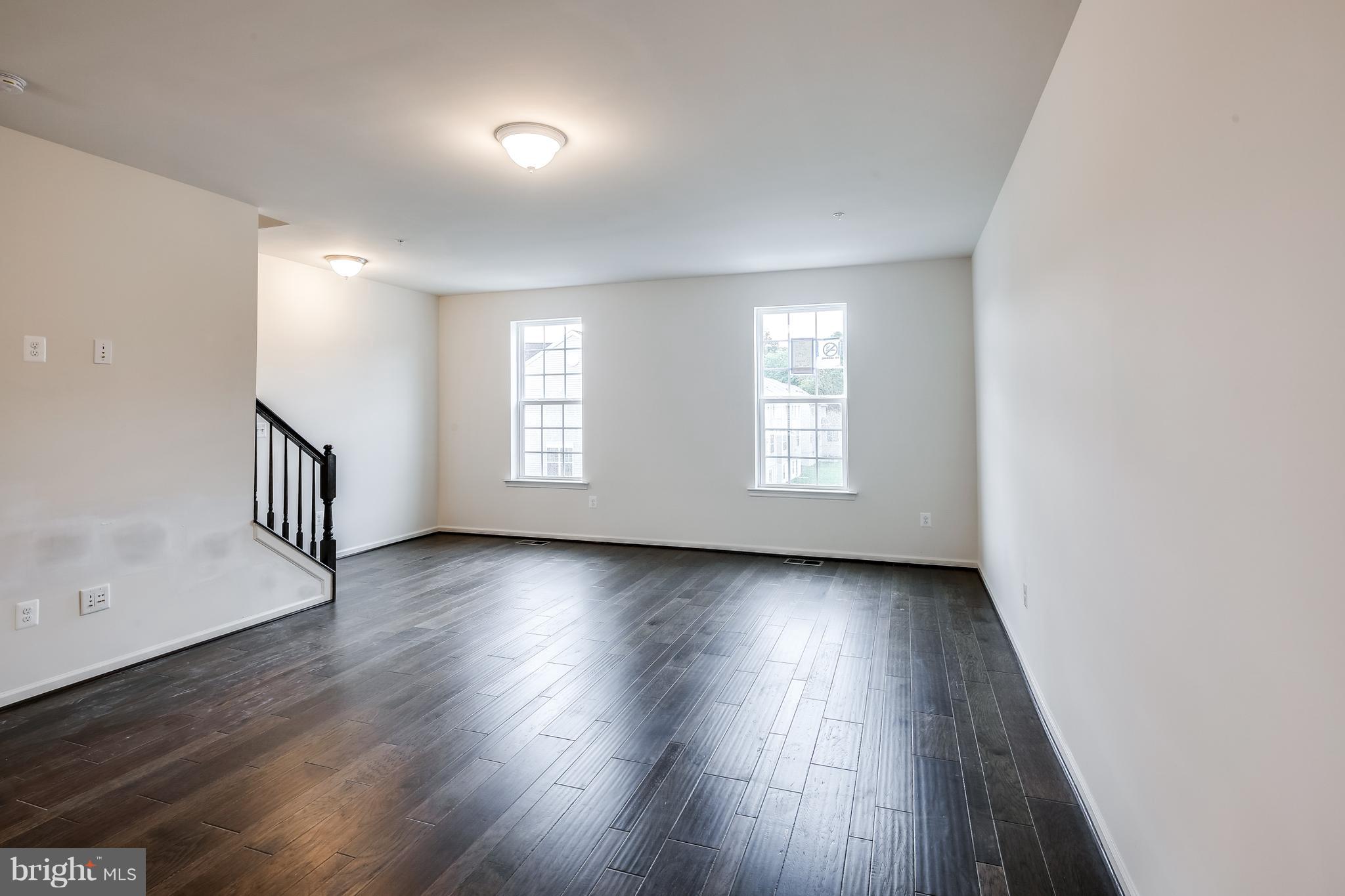 951 Morgan Run Road Middle River, MD 21220 - Photo 7 of 12 an empty room with wooden floor and windows