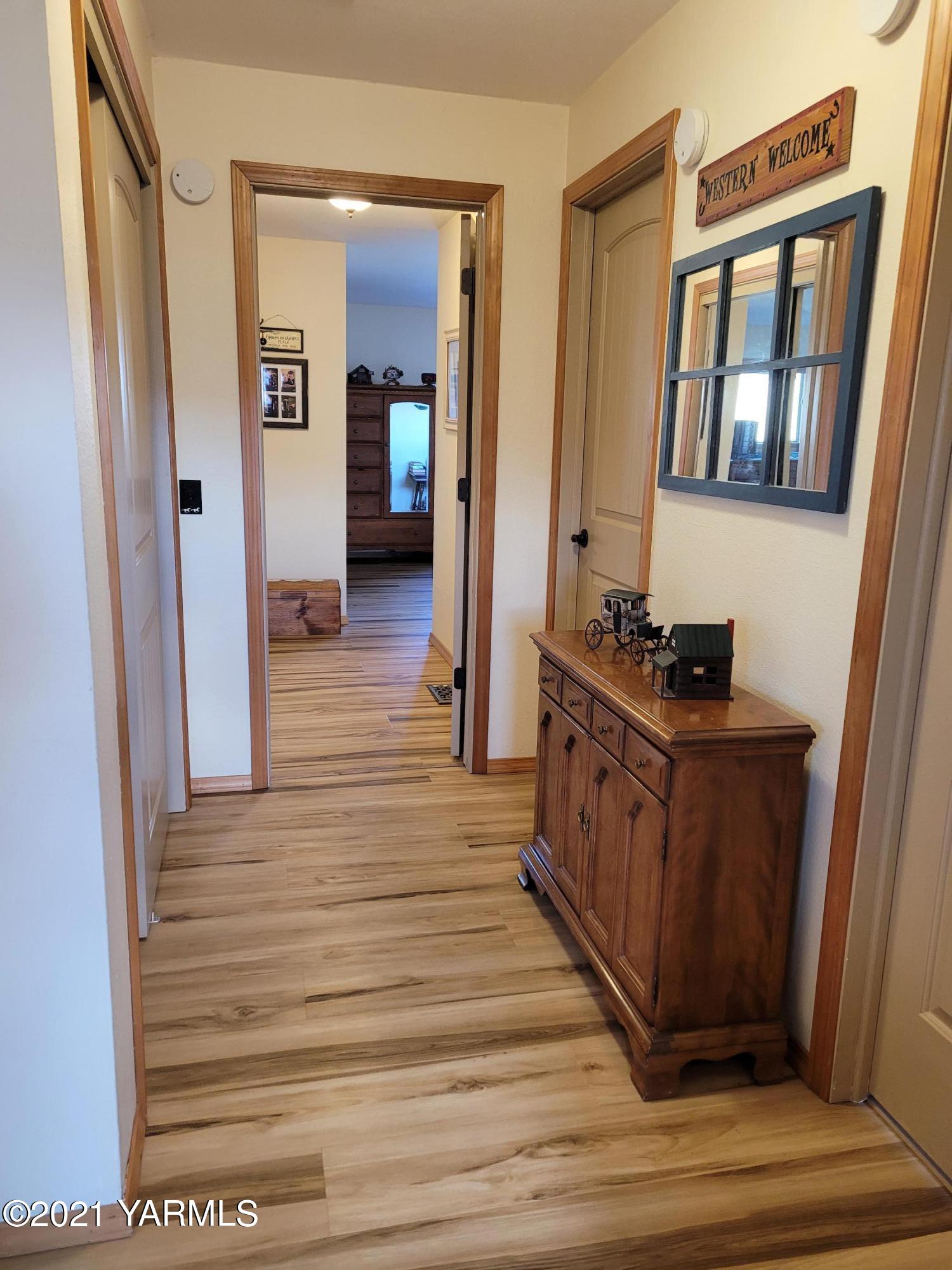 7773 North Wenas Road Selah, WA 98942 - Photo 25 of 45 a hallway view with wooden floor and staircase