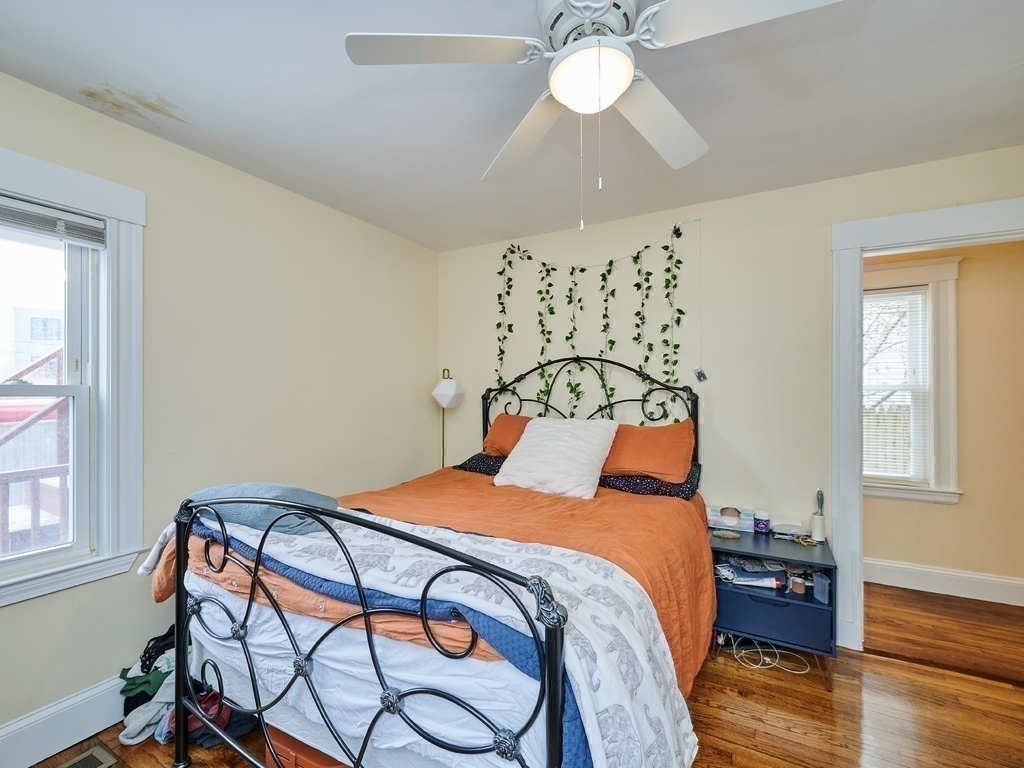 34 R Clyde Street Somerville, MA 02145 - Photo 11 of 31 a bedroom with a bed and a chandelier