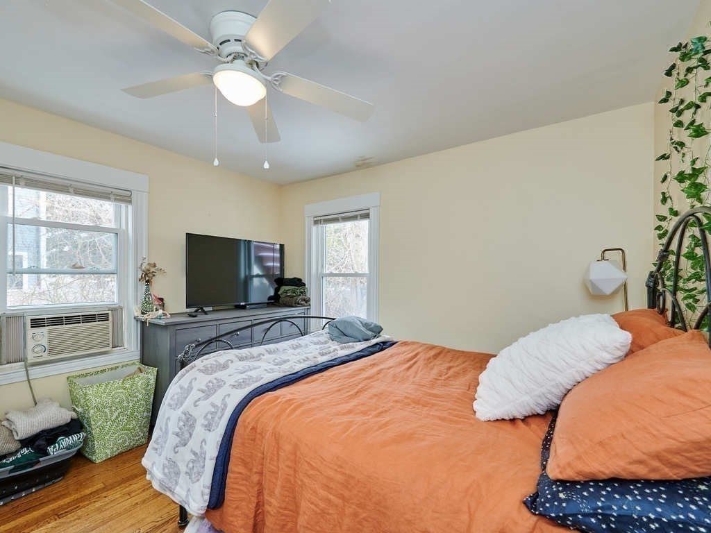 34 R Clyde Street Somerville, MA 02145 - Photo 12 of 31 a bedroom with a bed and a television