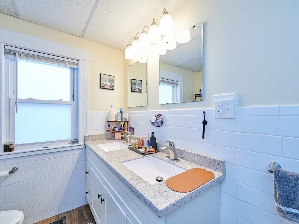 34 R Clyde Street Somerville, MA 02145 - Photo 13 of 31 a bathroom with a sink a vanity and a mirror