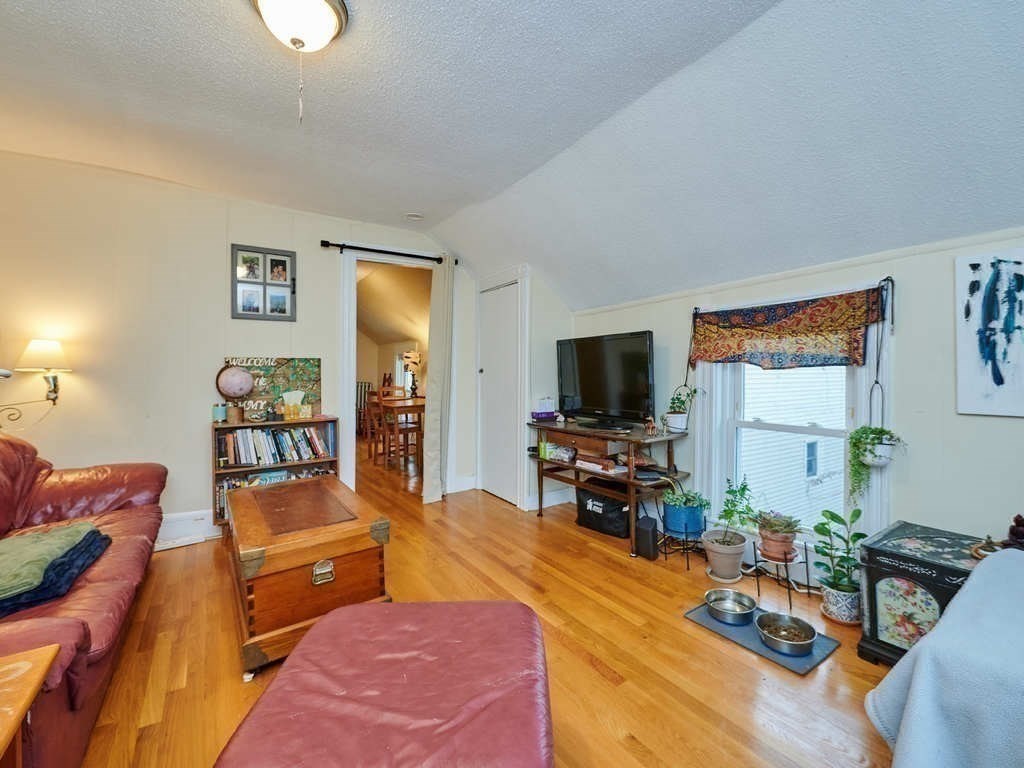 34 R Clyde Street Somerville, MA 02145 - Photo 16 of 31 a living room with furniture and a flat screen tv
