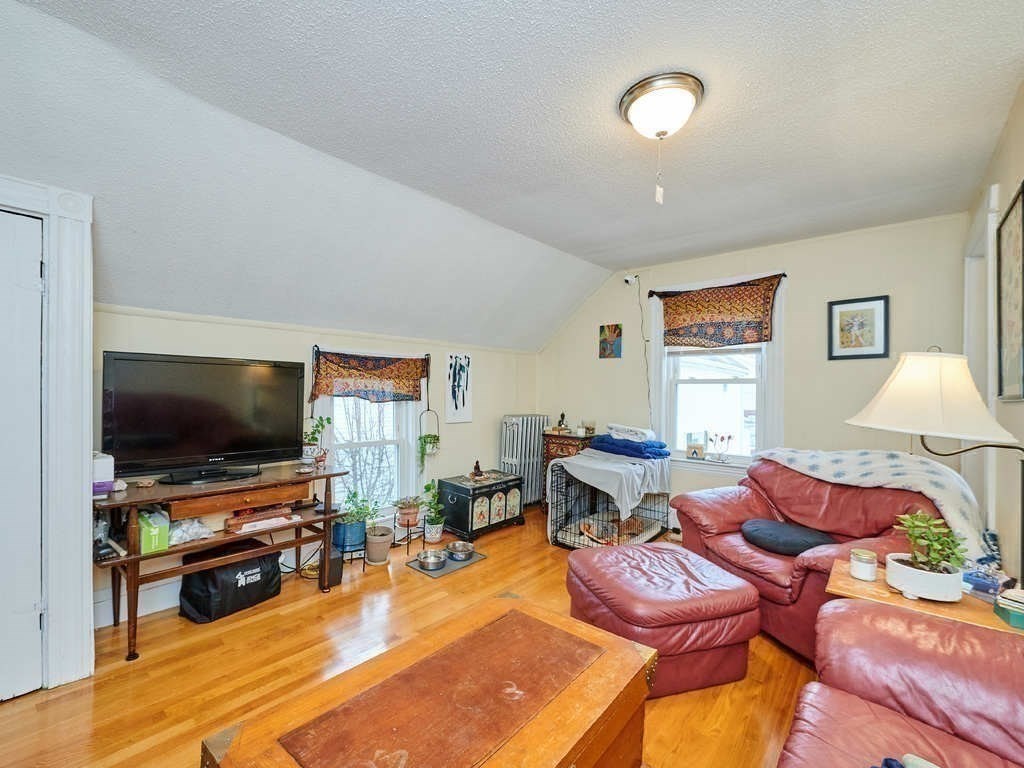 34 R Clyde Street Somerville, MA 02145 - Photo 17 of 31 a living room with furniture and a flat screen tv