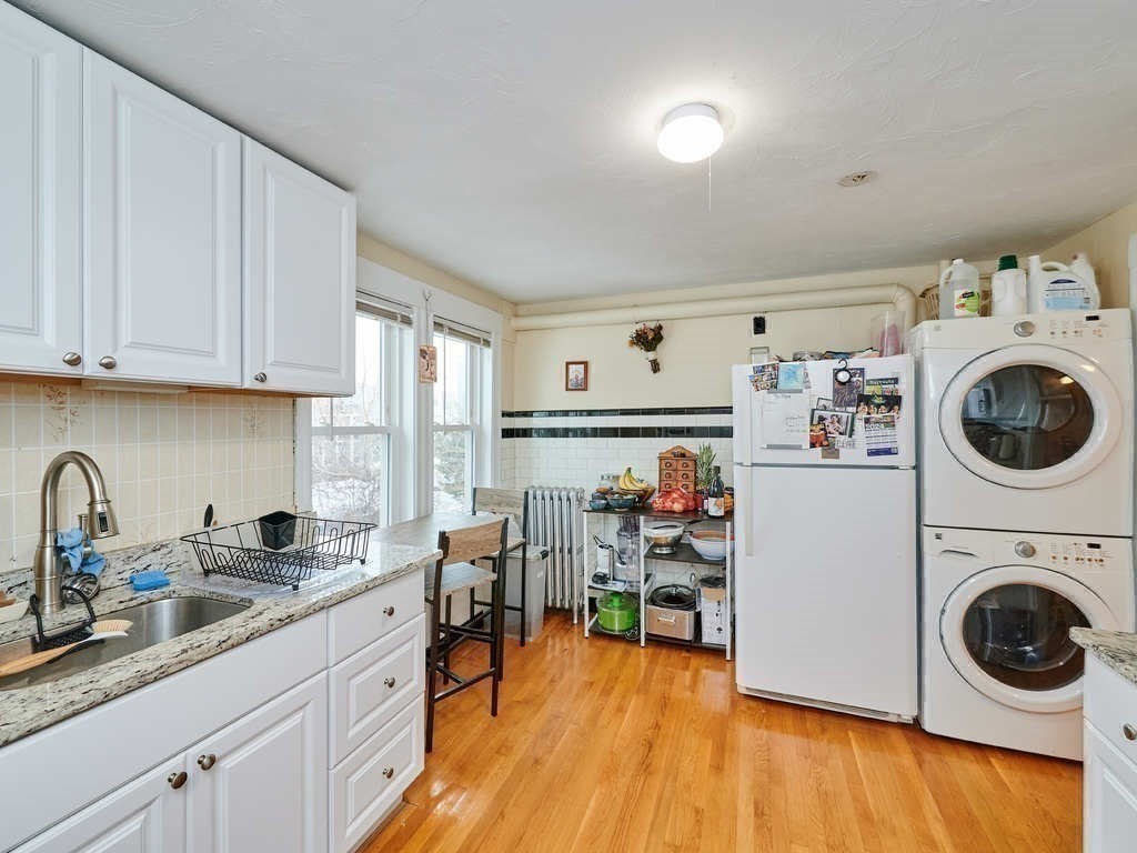 34 R Clyde Street Somerville, MA 02145 - Photo 19 of 31 a view of kitchen and sink with wooden floor