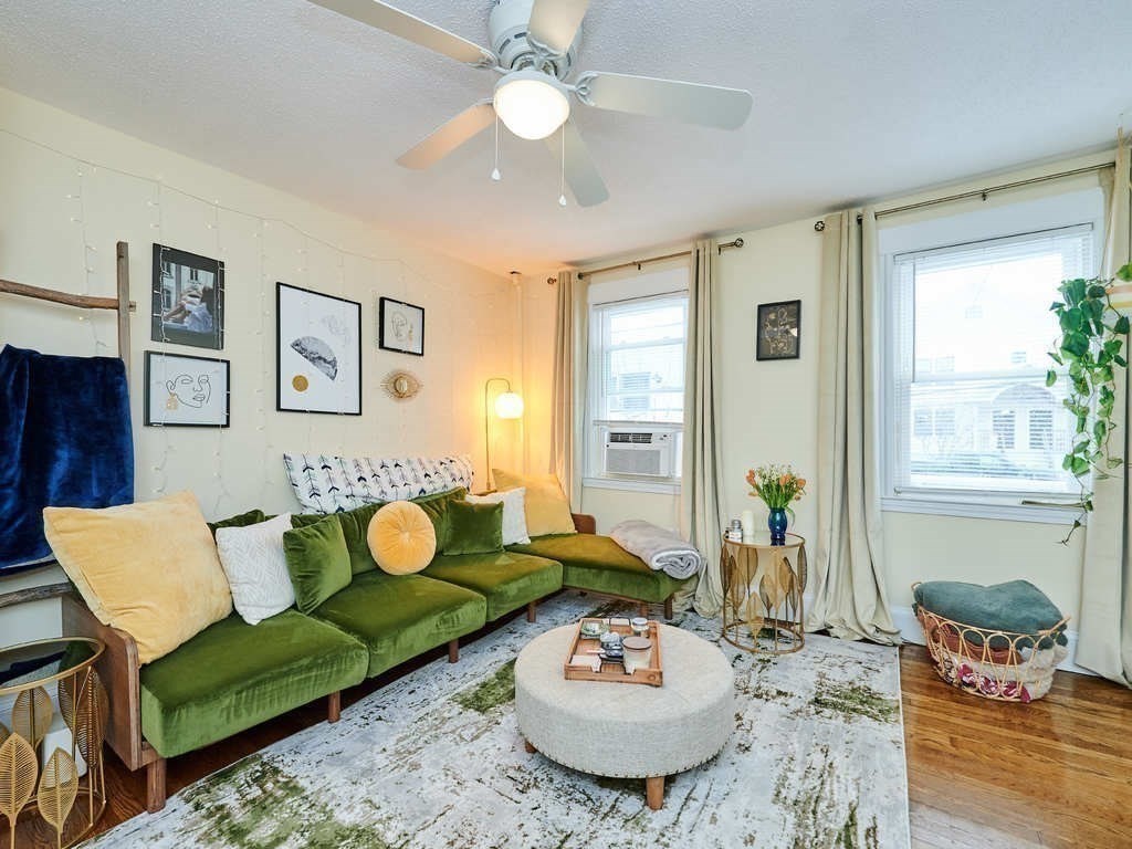 34 R Clyde Street Somerville, MA 02145 - Photo 5 of 31 a living room with furniture and a dining table with garden view