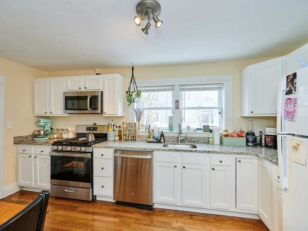 34 R Clyde Street Somerville, MA 02145 - Photo 9 of 31 a kitchen with a sink stove and microwave