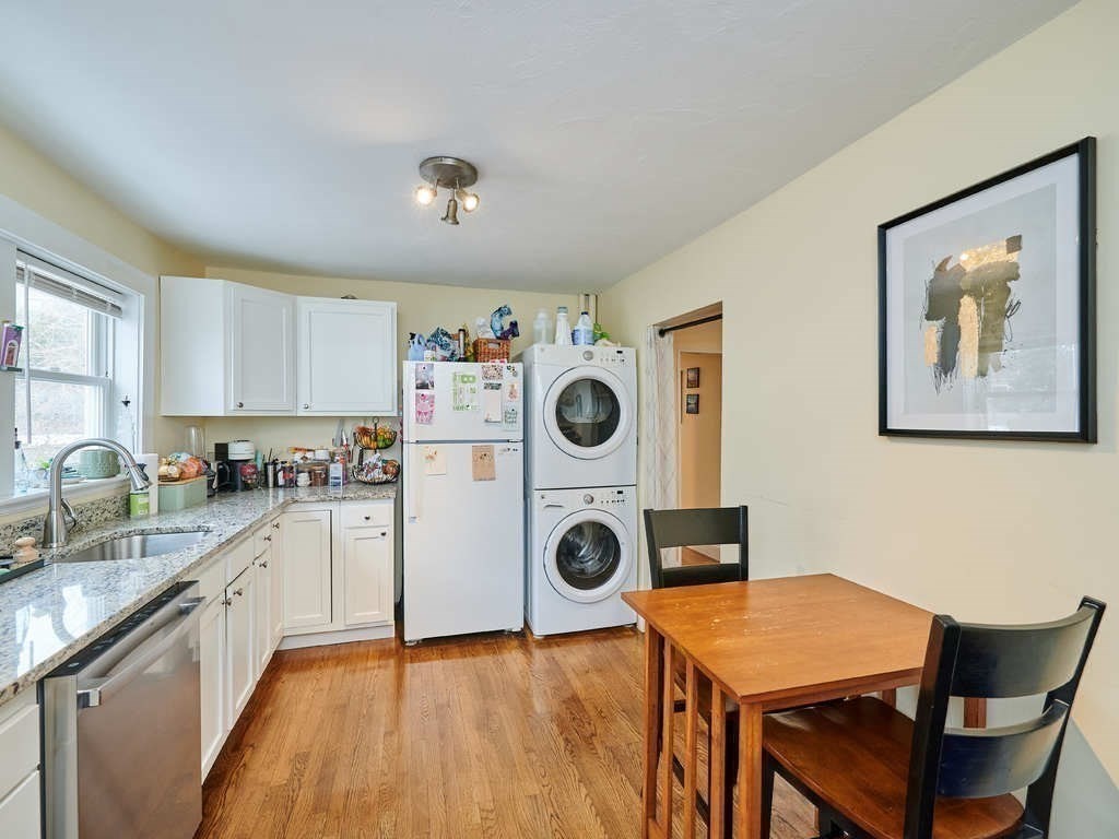 34 R Clyde Street Somerville, MA 02145 - Photo 10 of 31 a kitchen with a table chairs refrigerator and sink