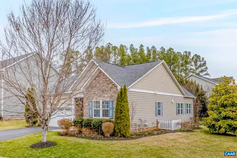 a view of a house with a yard covered in snow