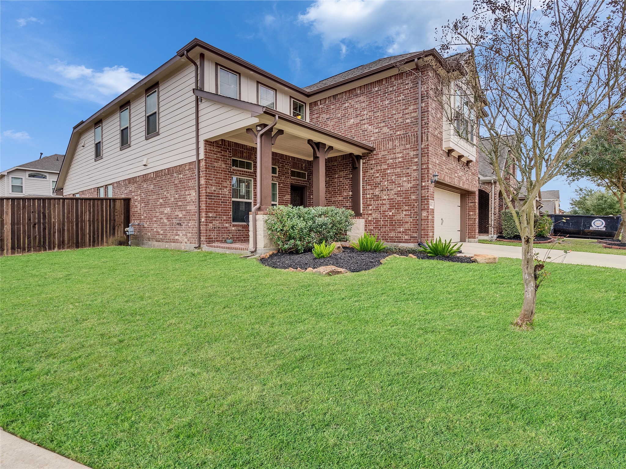 6530 Hunters Creek Lane Baytown, TX 77521 - Photo 2 of 40 a front view of a house with a yard and garage