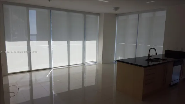 a kitchen with a sink a refrigerator and cabinets