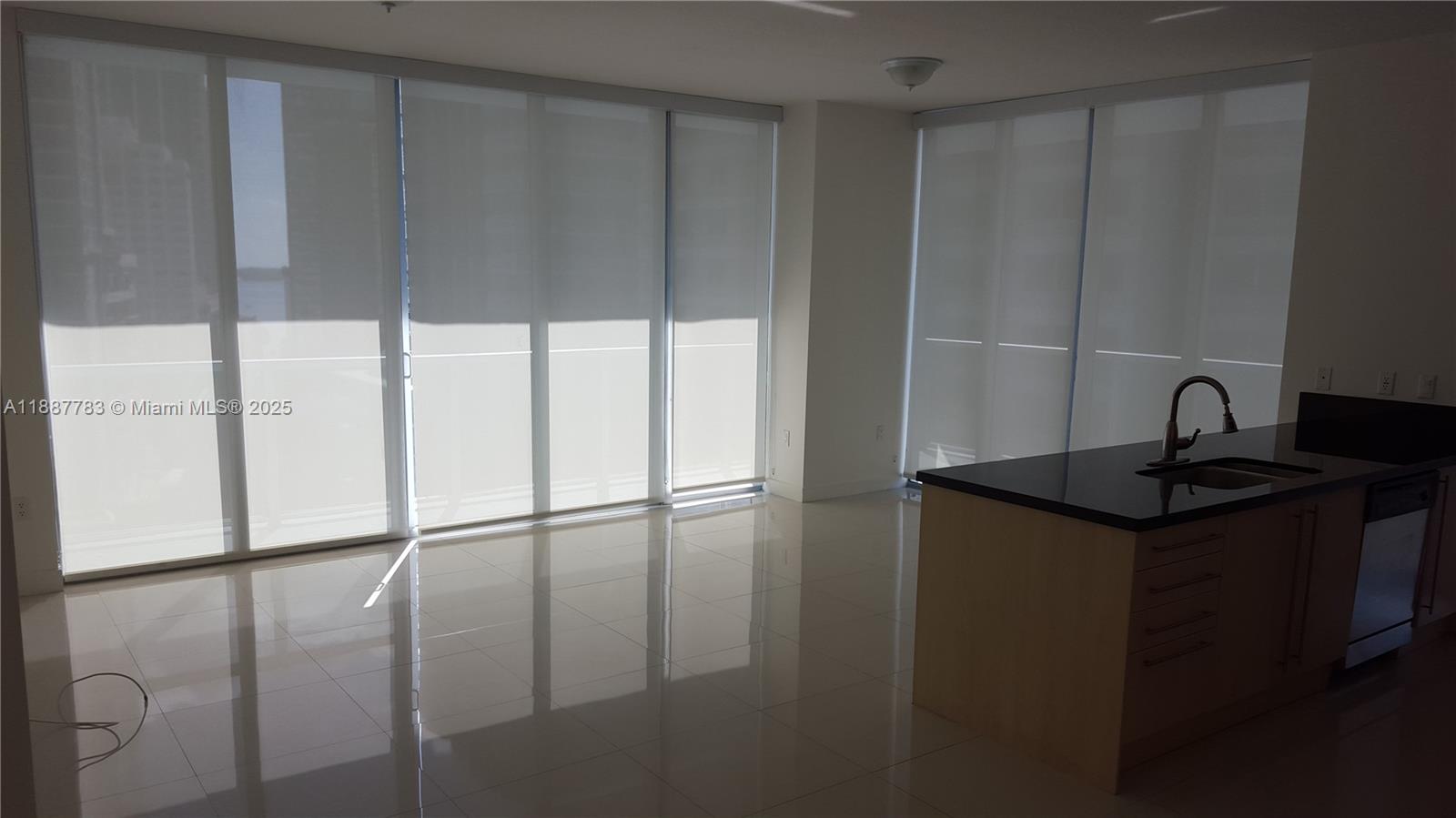 a kitchen with a sink a refrigerator and cabinets