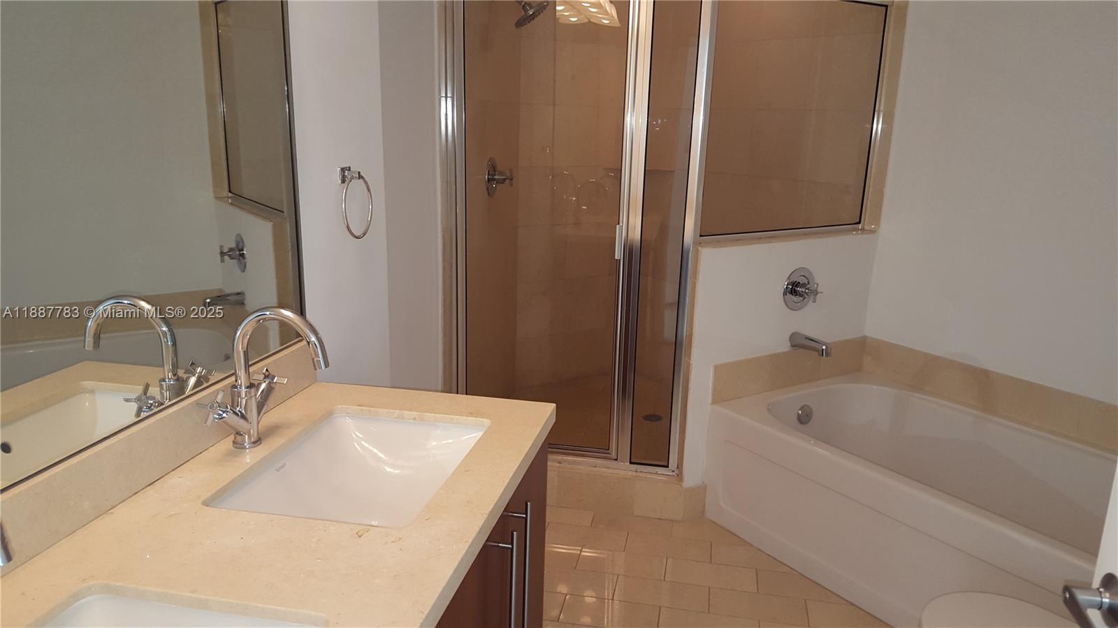 79 Southwest 12th Street, Unit 1506S Miami, FL 33130 - Photo 4 of 6 a bathroom with a sink and a bathtub