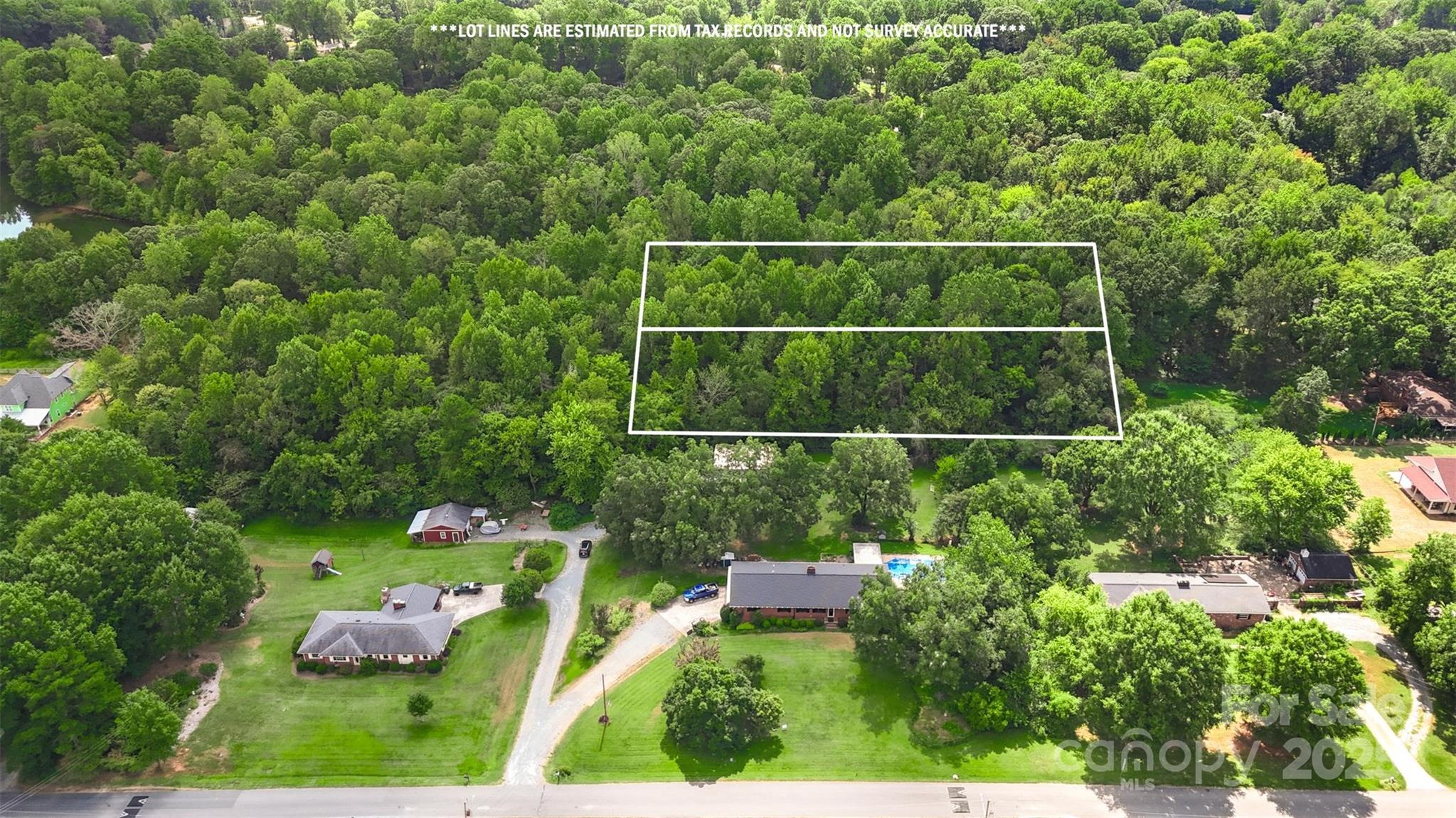 8503 Tuckalake Road Charlotte, NC 28215 - Photo 4 of 5 a view of a chair and tables back yard of the house