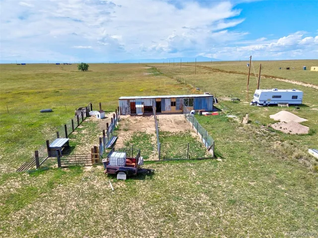 a view of a lake with table and chairs