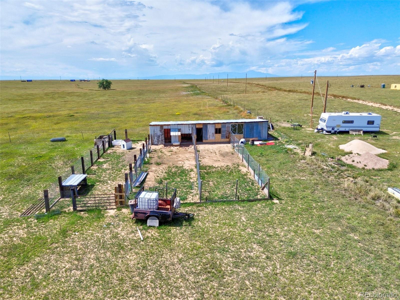 11235 Boone Road Yoder, CO 80864 - Photo 16 of 22 a view of a lake with table and chairs