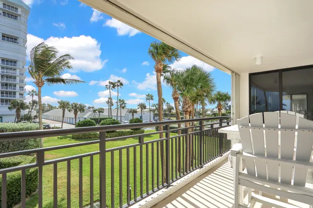 a view of a balcony with lake view and wooden floor