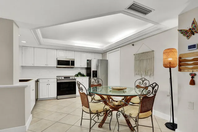 a view of kitchen with refrigerator stove and wooden floor