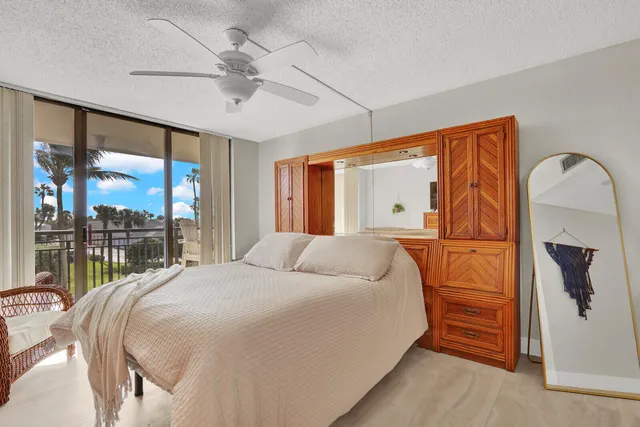 a bedroom with a large bed and a large window