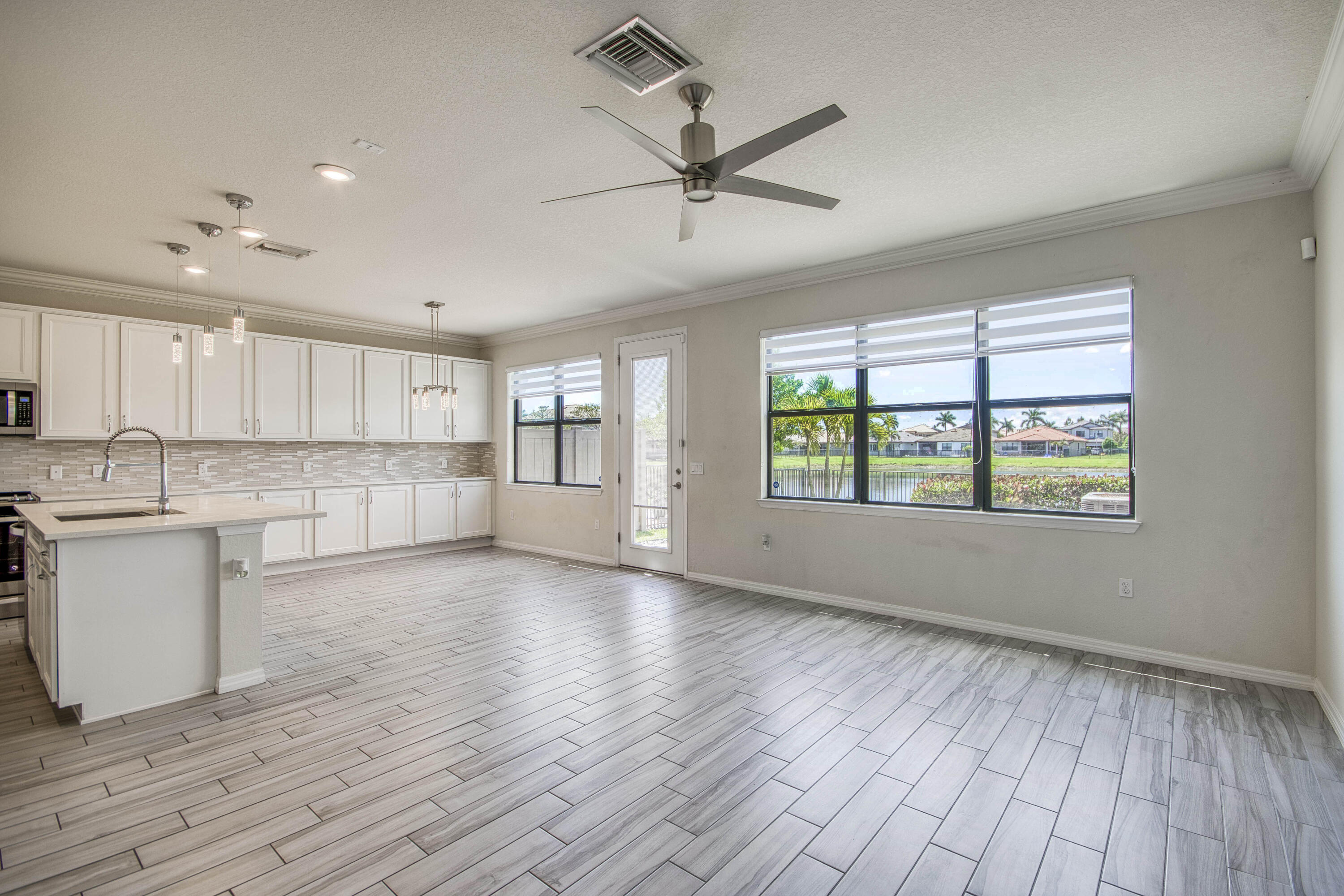 8301 Rearing Lane Lake Worth, FL 33467 - Photo 6 of 33 a view of a kitchen with wooden floor and a window