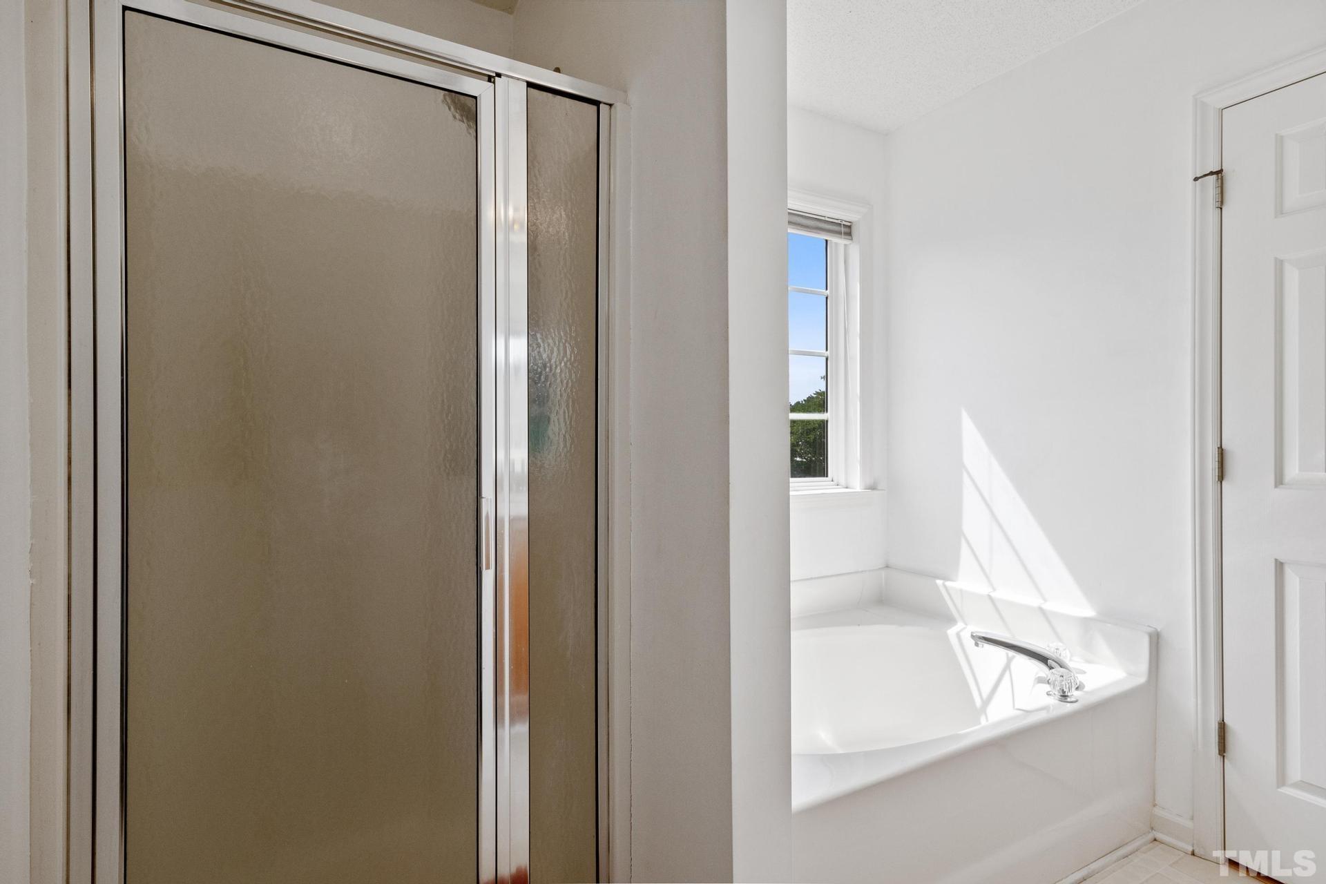 4213 Somerset Valley Lane Raleigh, NC 27616 - Photo 23 of 31 a bathroom with a bathtub and a shower