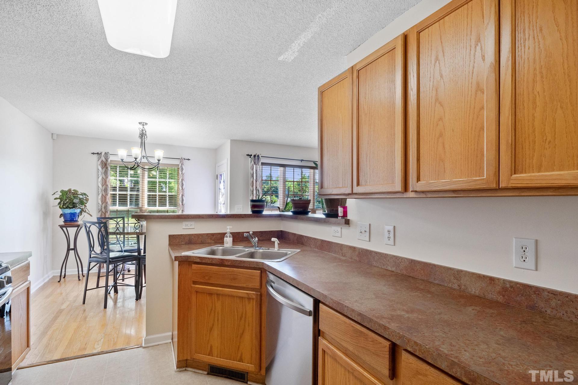 4213 Somerset Valley Lane Raleigh, NC 27616 - Photo 26 of 31 a kitchen with stainless steel appliances granite countertop a stove a sink and a microwave