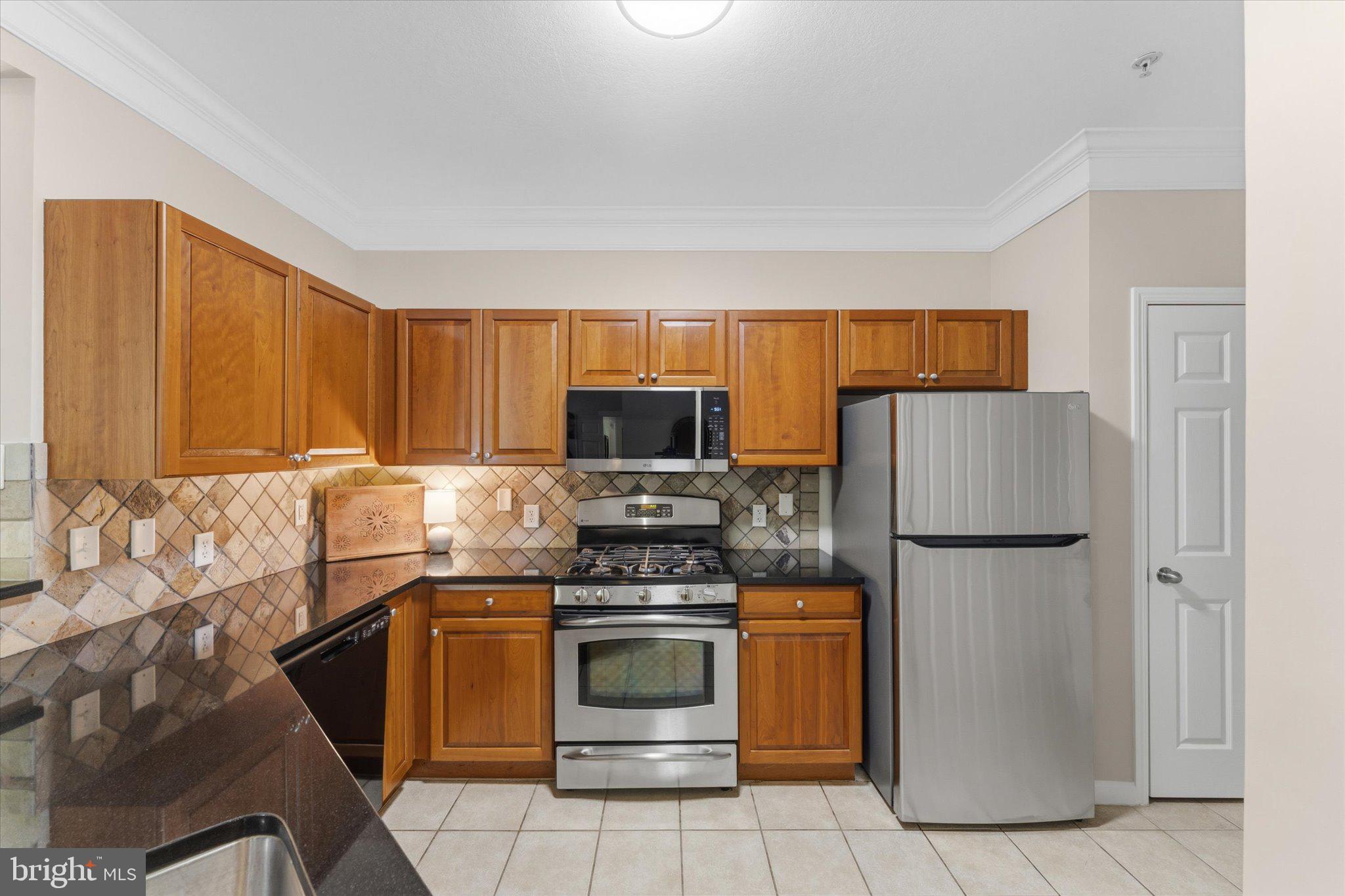 503 Sunset View Terrace Southeast, Unit 101 Leesburg, VA 20175 - Photo 6 of 39 Modern kitchen with warm wood tones.