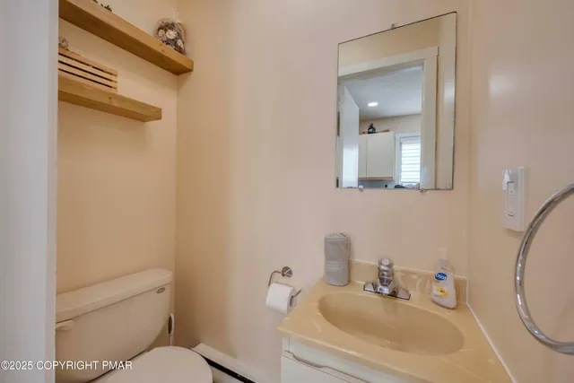 a bathroom with a sink toilet and mirror