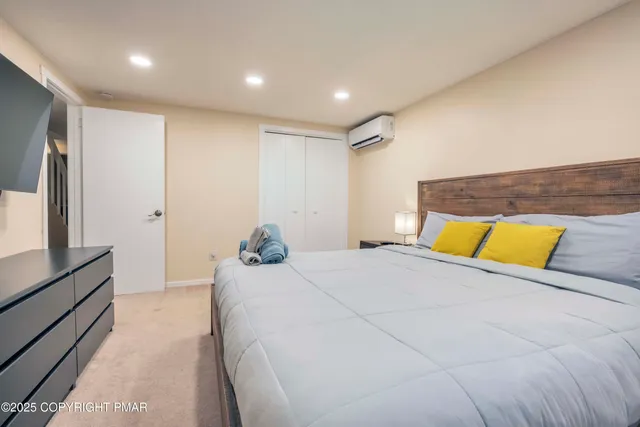 a bedroom with a large bed and a large mirror