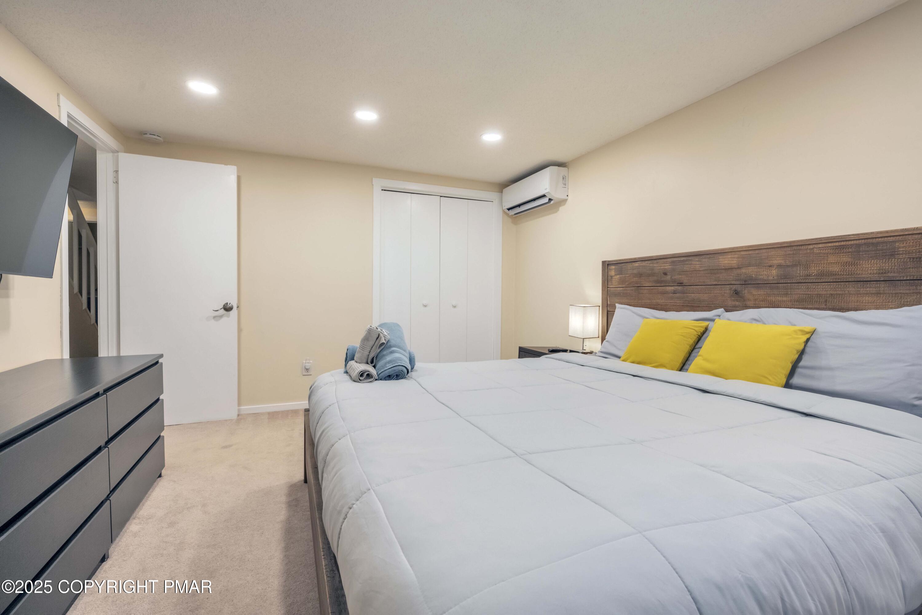 147 Cross Country Lane Tannersville, PA 18372 - Photo 21 of 39 a bedroom with a large bed and a large mirror