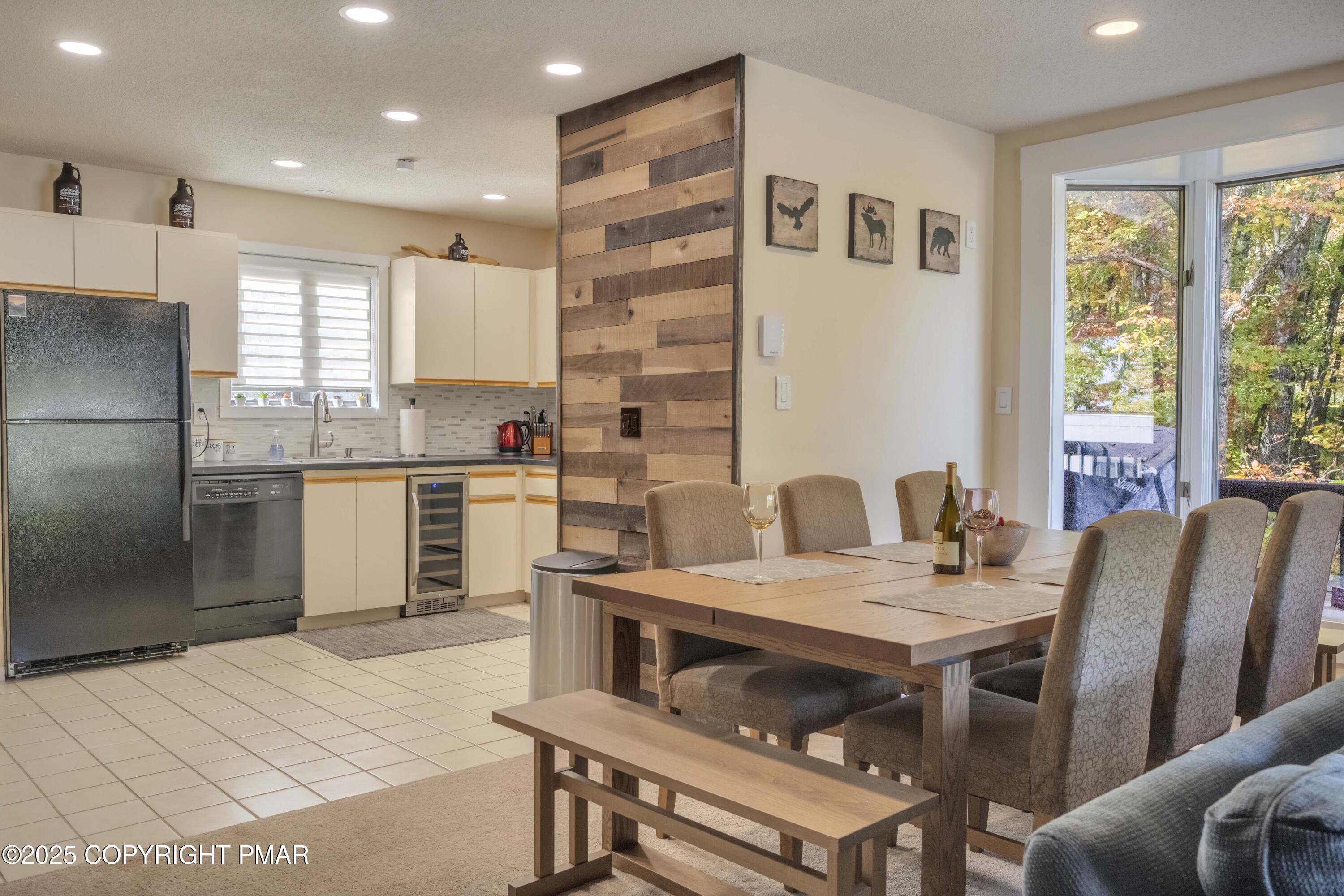 147 Cross Country Lane Tannersville, PA 18372 - Photo 4 of 39 a kitchen with a refrigerator a stove a sink dishwasher with a dining table and chairs