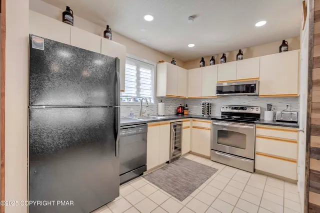 a kitchen with a refrigerator and a stove top oven