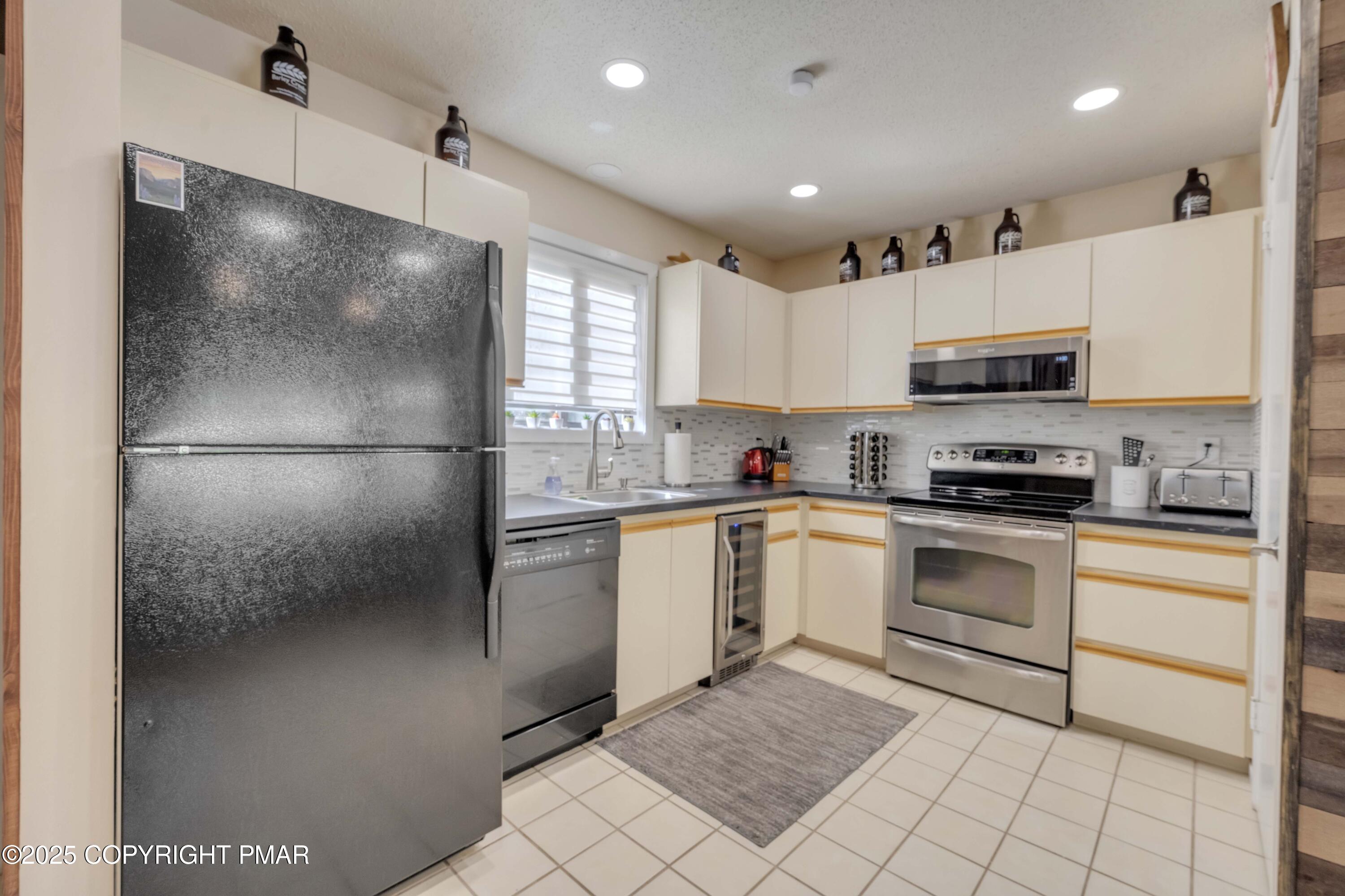 147 Cross Country Lane Tannersville, PA 18372 - Photo 7 of 39 a kitchen with a refrigerator and a stove top oven