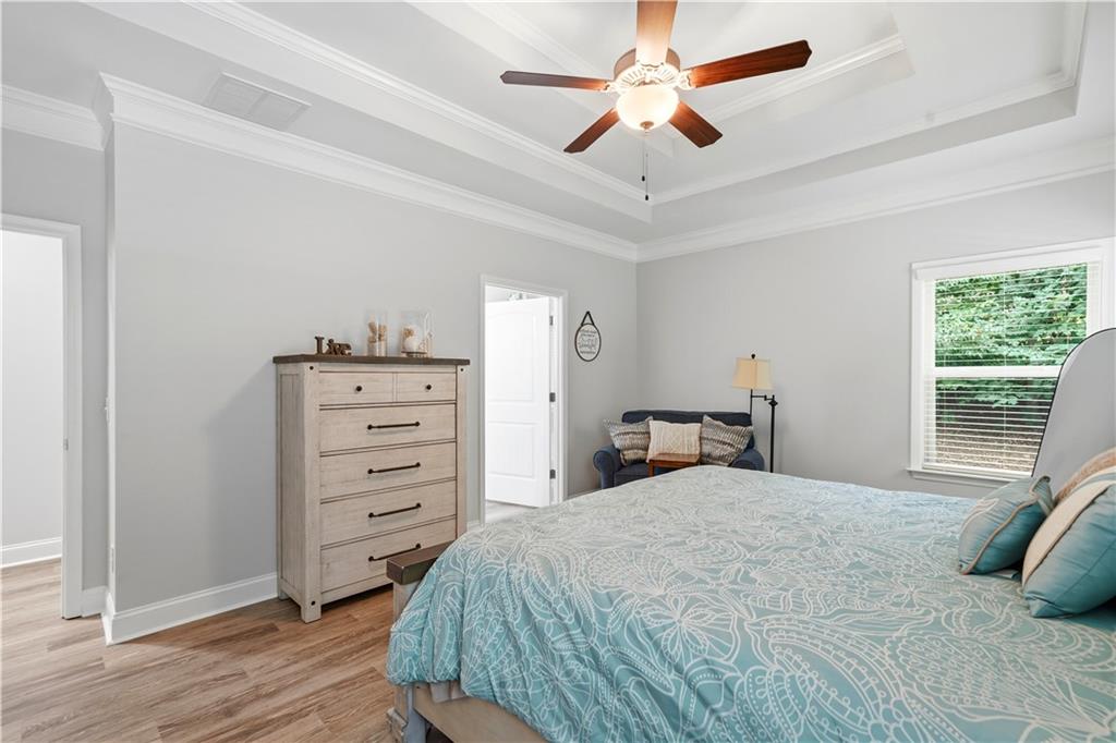 302 Spence Circle Ball Ground, GA 30107 - Photo 25 of 55 a bedroom with a bed a dresser and a window