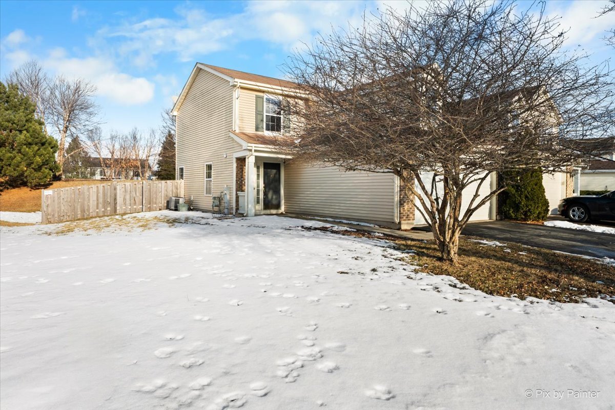 a view of a house with a snow in the yard