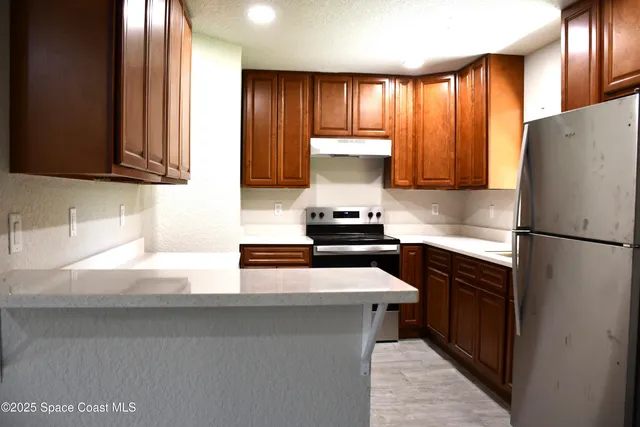 a kitchen with a refrigerator and a sink