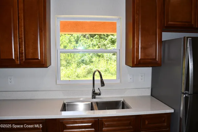 a kitchen with a sink and large window