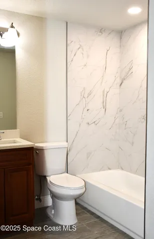 a bathroom with a toilet a sink and bathtub