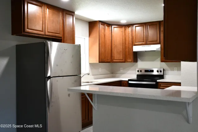a kitchen with a refrigerator and a cabinets