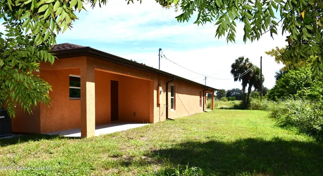 a front view of house with yard and trees