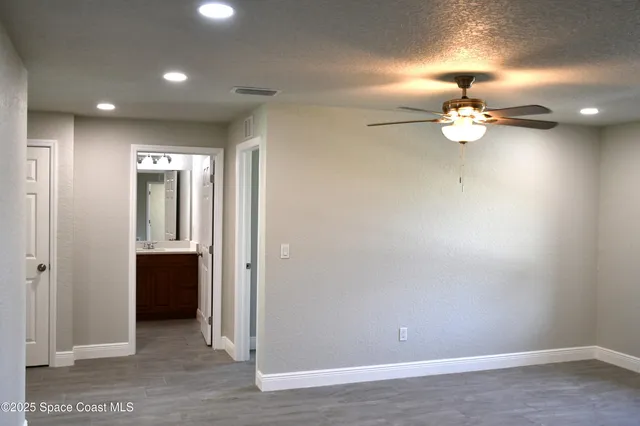 a view of a chandelier fan and a wooden floor