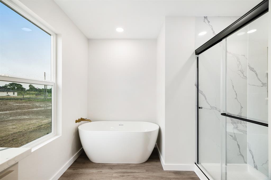 59 Private Road Brookston, TX 75421 - Photo 15 of 26 a bathroom with a bathtub and shower