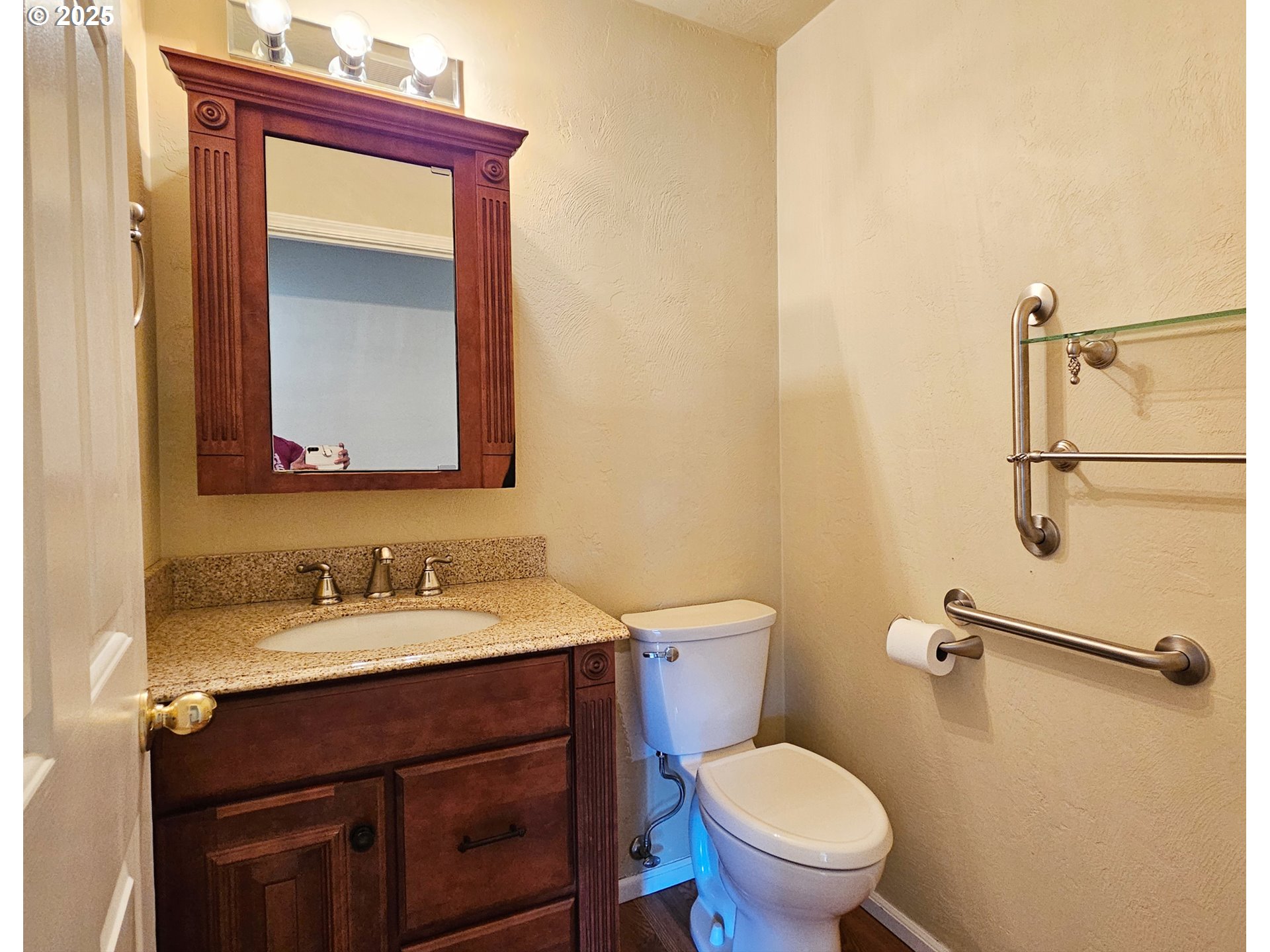 6827 D Street Springfield, OR 97478 - Photo 8 of 23 a bathroom with a toilet sink and mirror